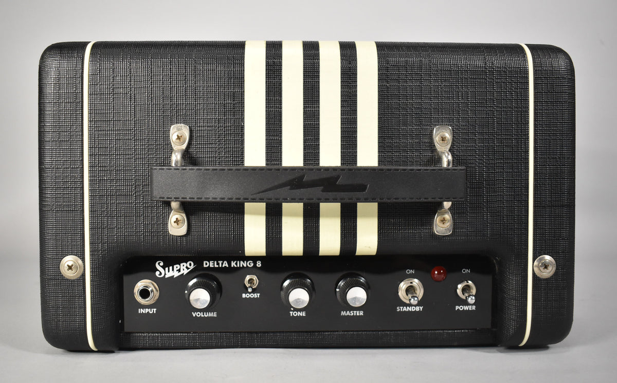 Black Supro Delta King 8 guitar amp with white stripes, a black handle, and control panel with input, volume, boost, tone, master, standby, and power.