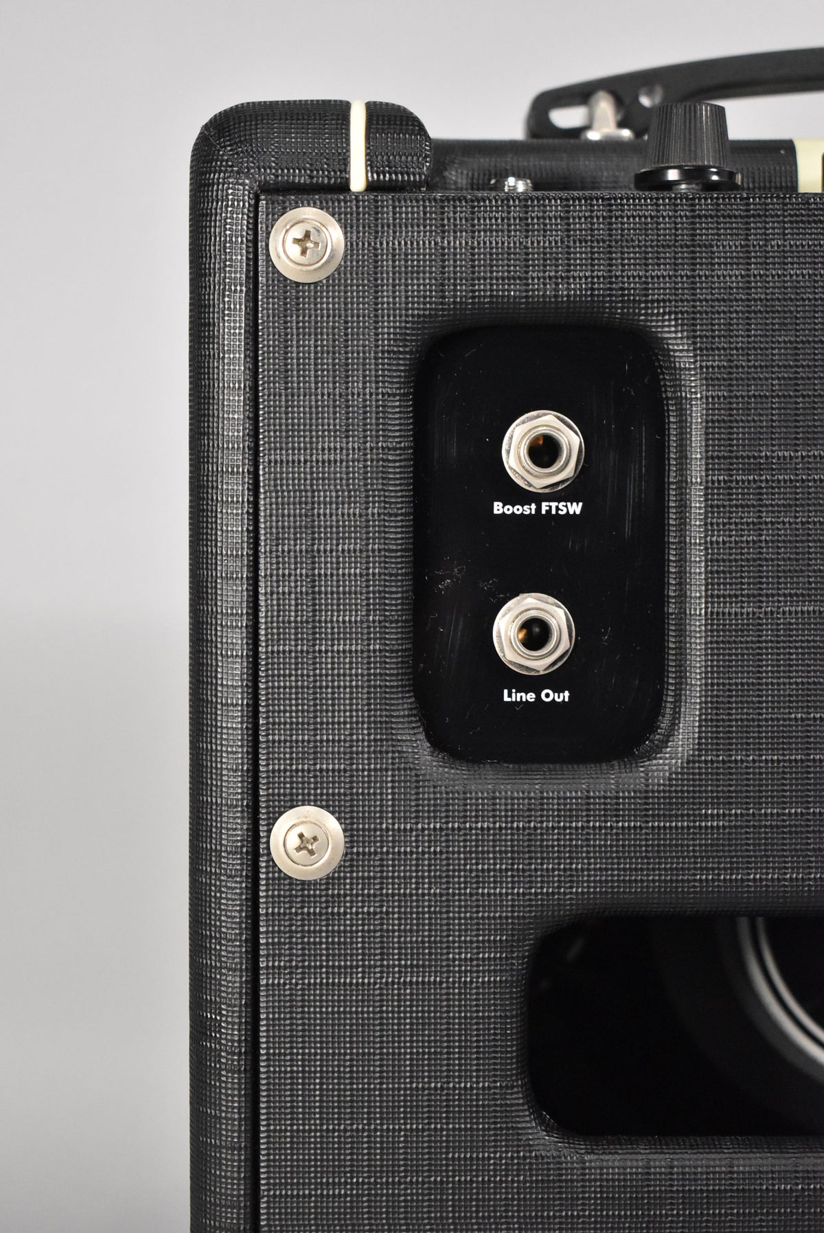 Close-up of the amp's black textured side, showing "Boost FTSW" and "Line Out" jacks, with a hint of the speaker below.
