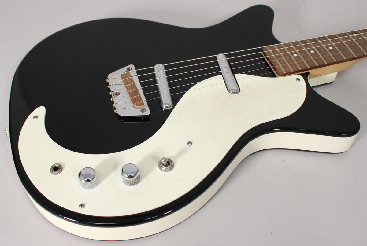 Black gloss electric guitar body with a large cream pickguard, two chrome knobs, a toggle switch, and two lipstick-style pickups.