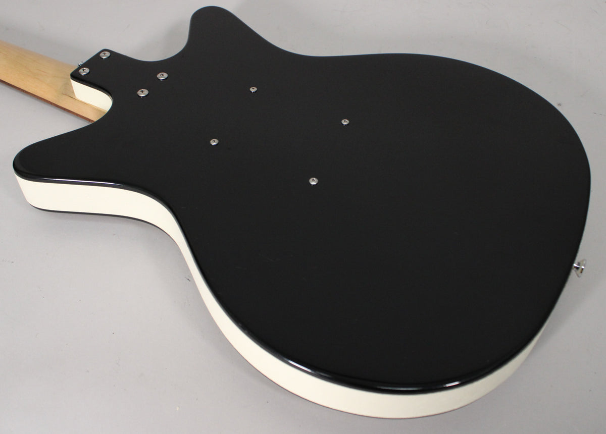 The back of a black gloss guitar body with cream binding, showing the neck joint and six silver screws.