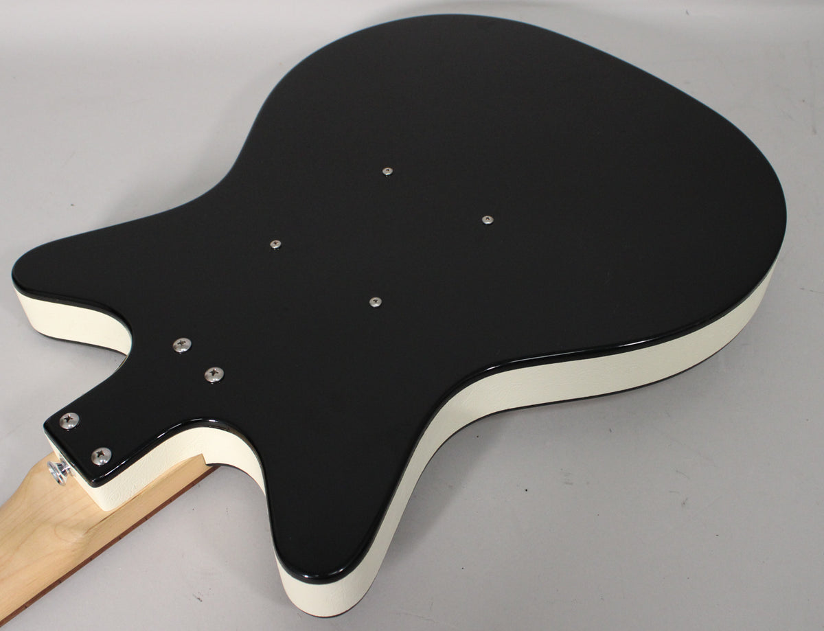 The guitar's glossy black back and white sides are visible, with four silver screws near the neck joint and four more on the body.