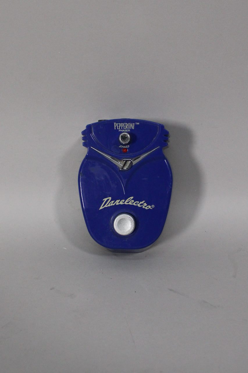 A top-down view of a blue, rounded guitar pedal with a single silver knob, a red indicator light, and a large silver footswitch.