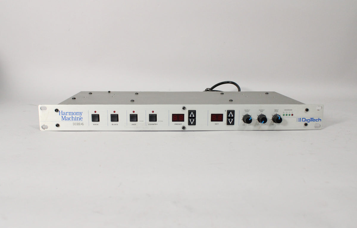 A light grey rackmount unit with black buttons, red digital displays, black up/down arrows, and three black knobs.