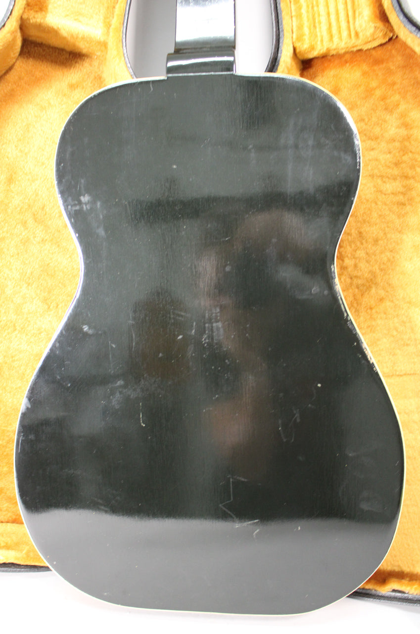 The back of the black resonator guitar shows many light scratches and scuffs, with white binding visible along the edges.