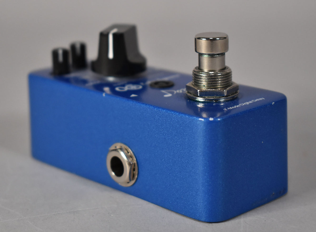 A blue metallic effect pedal, angled to show the input jack, footswitch, and three black control knobs with minor paint chips.
