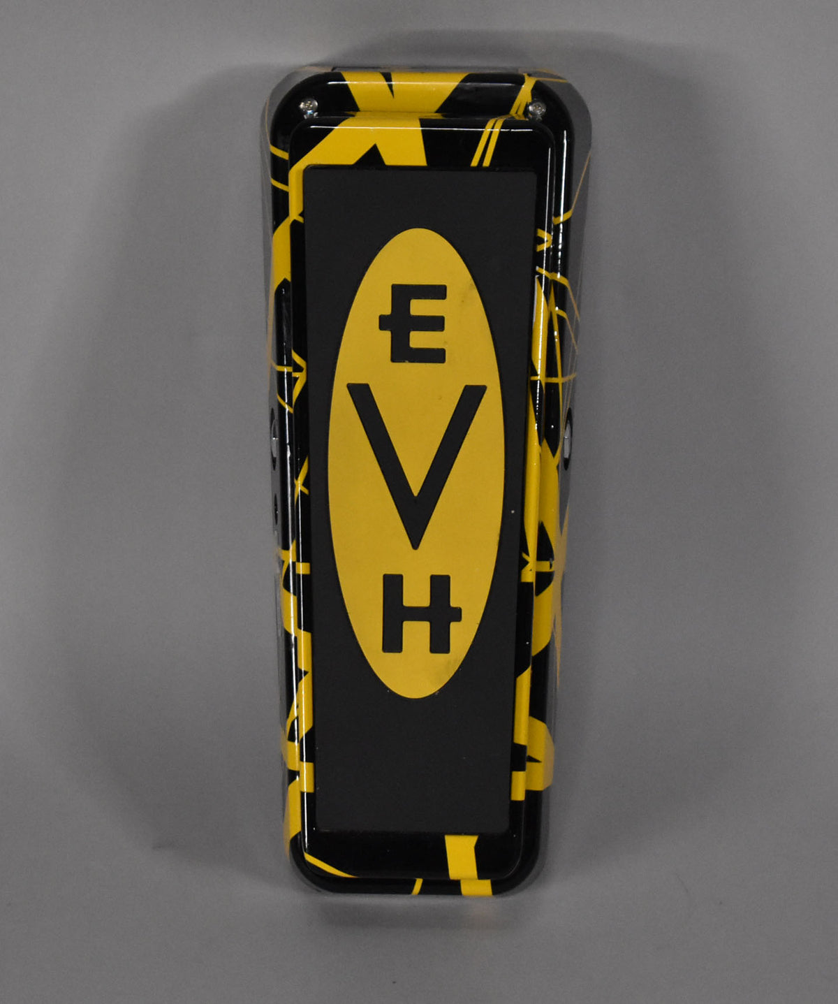The wah pedal is shown from above, featuring a black and yellow striped finish with a central black footpad.