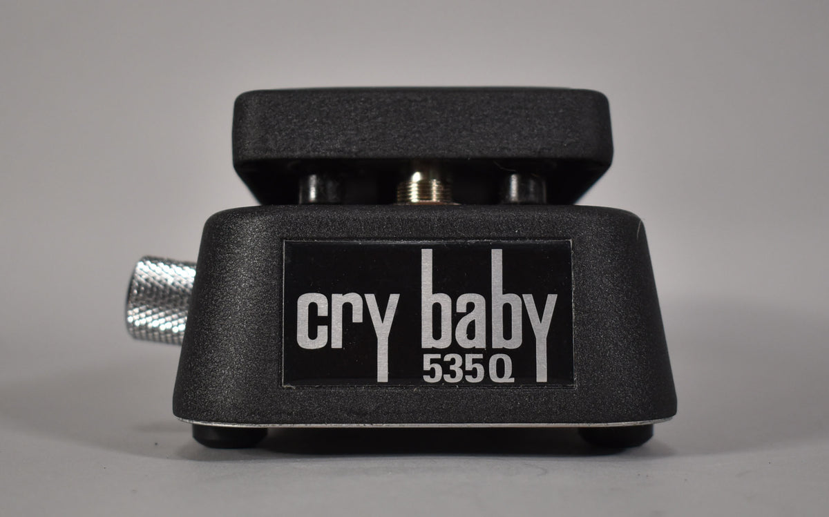Front view of a black textured wah pedal with a silver knurled knob on the left side and a black label.