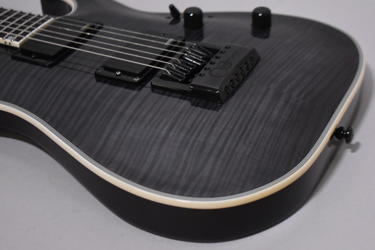 The lower body of a charcoal burst electric guitar, showing the EverTune bridge, two humbuckers, and cream binding.