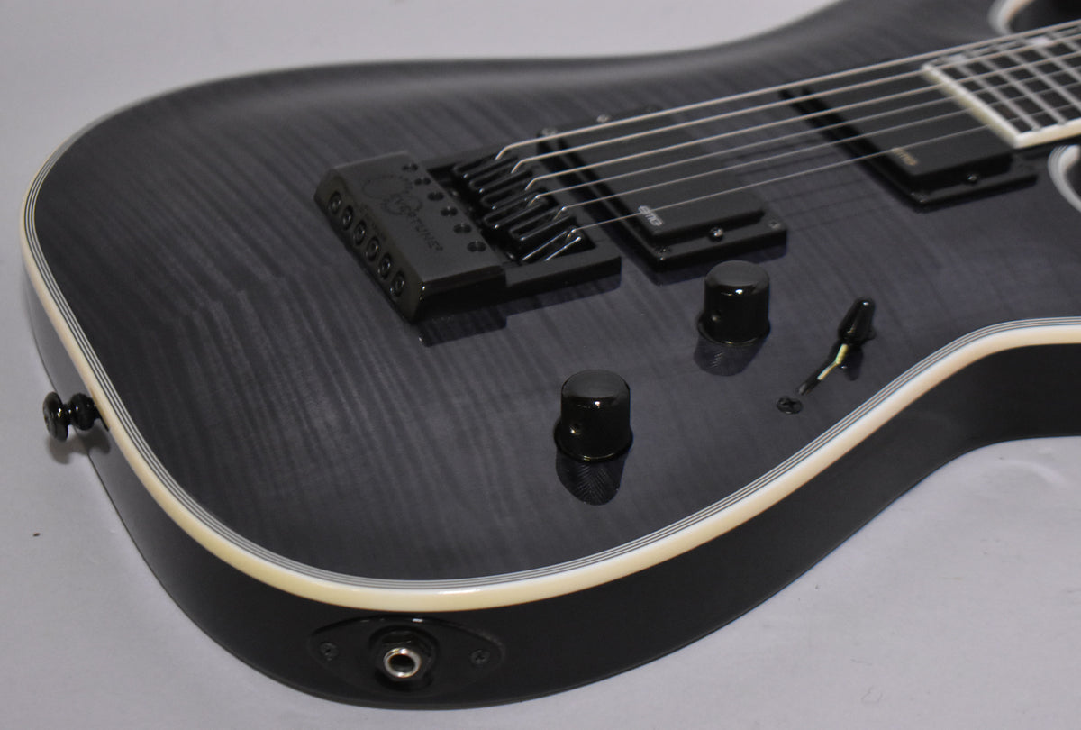 The lower bout of a charcoal burst guitar, showing the EverTune bridge, two black humbuckers, two black control knobs, and a toggle switch.