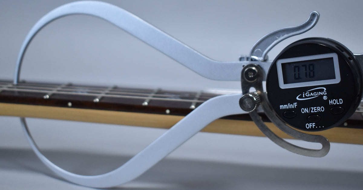 A digital fret height gauge measures the guitar's fretboard, showing a reading of 0.78mm on its display.
