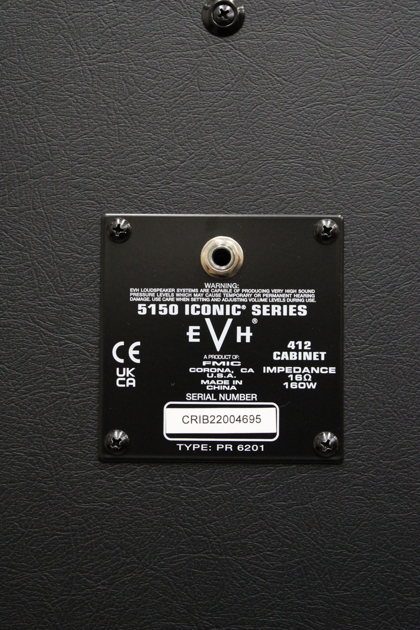 Close-up of the black textured rear panel, showing a recessed metal input jack and a black data plate with white text.