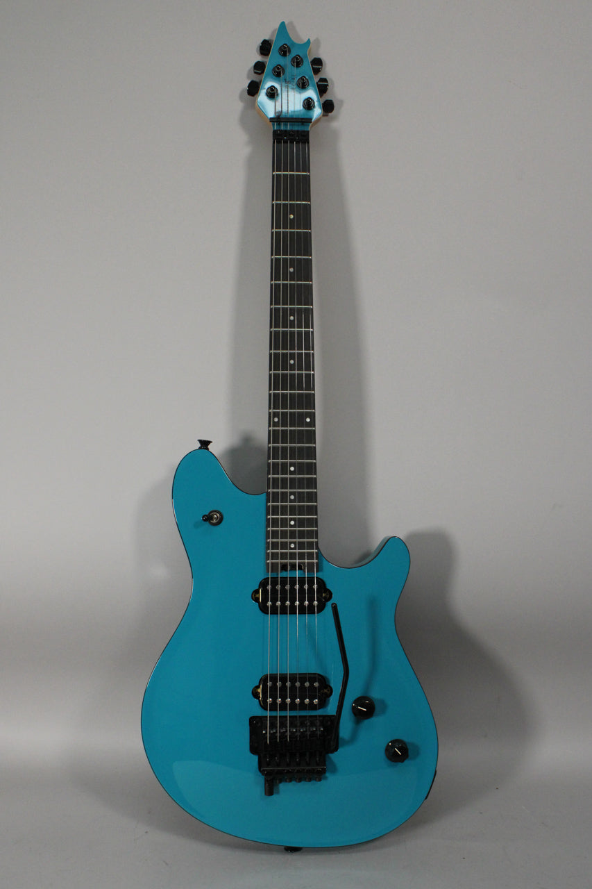 Full-length view of a bright blue electric guitar with a glossy finish, black hardware, two humbucker pickups, and a tremolo system.