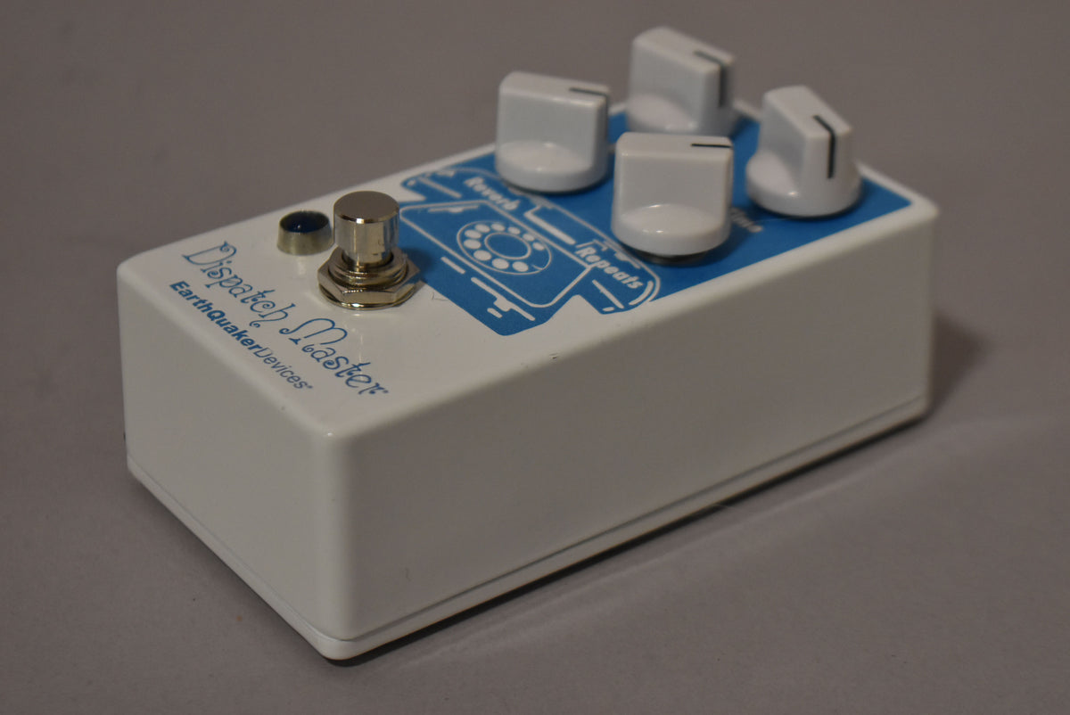 White pedal with blue graphics of a rotary phone, four white knobs, and a chrome footswitch, viewed from the front right.