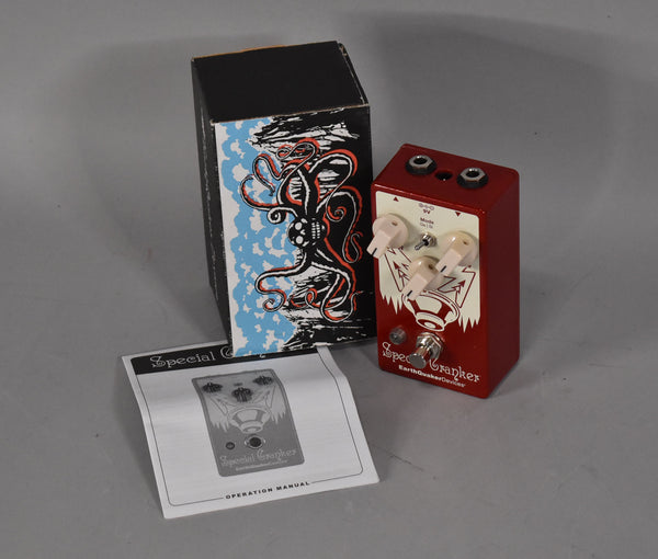 Red pedal with white graphics, three cream knobs, a toggle switch, and a footswitch, shown with its box and manual.