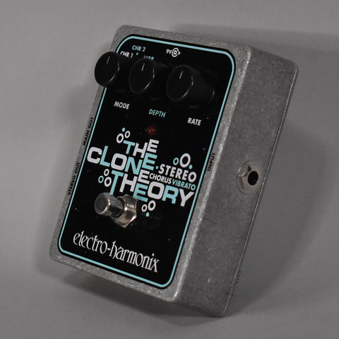 A grey metal pedal with a black faceplate, three black knobs, a silver footswitch, and an input jack on the right side.