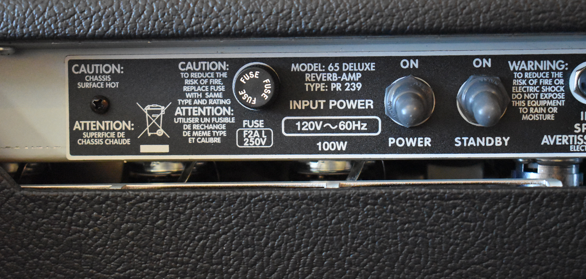 Close-up of the amp's rear panel, showing the fuse, power, and standby switches, with a textured black tolex finish below.