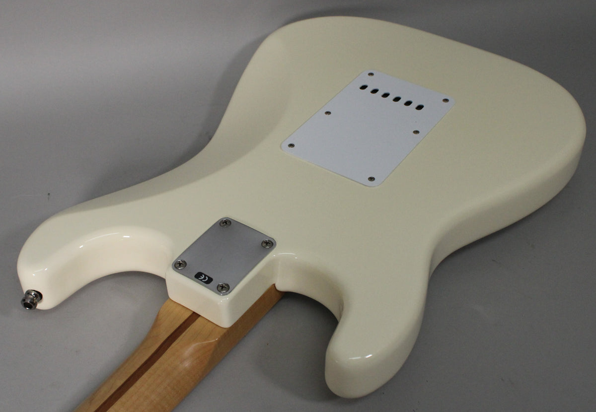 The back of an Olympic White Stratocaster body, showing the tremolo spring cover, neck plate, and strap button.