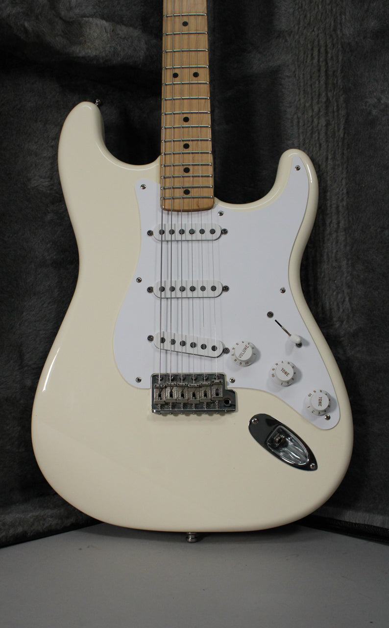 Full-frame view of an Olympic White Stratocaster with a maple fretboard, white pickguard, three single-coil pickups, and chrome hardware.