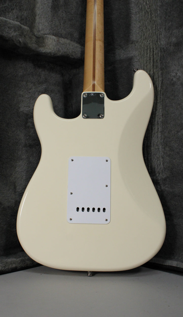 The back of an Olympic White Stratocaster, showing the neck plate, maple neck, and white tremolo cover with six holes.