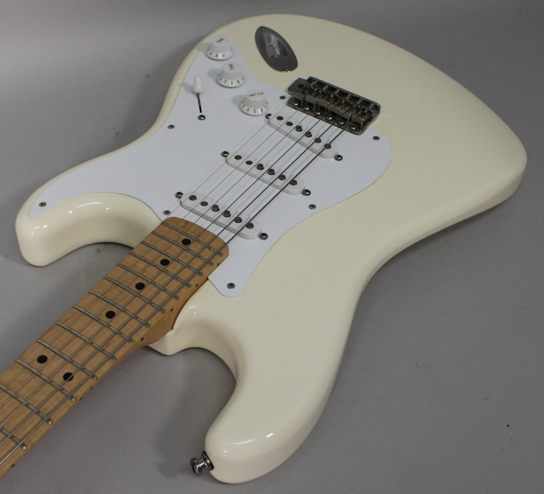 Overhead view of an Olympic White Stratocaster, showing the body, white pickguard, three single-coil pickups, and maple fretboard.