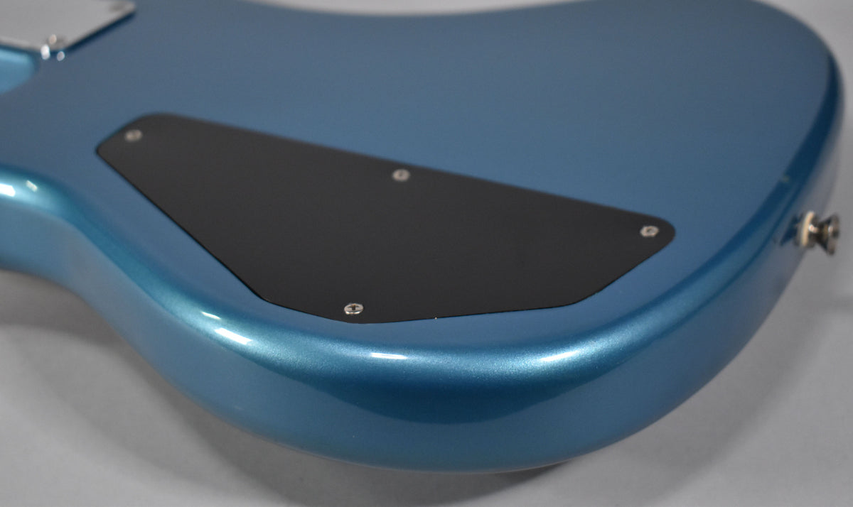 The Lake Placid Blue bass body, viewed from the back, shows a black control cavity cover and a chrome output jack.