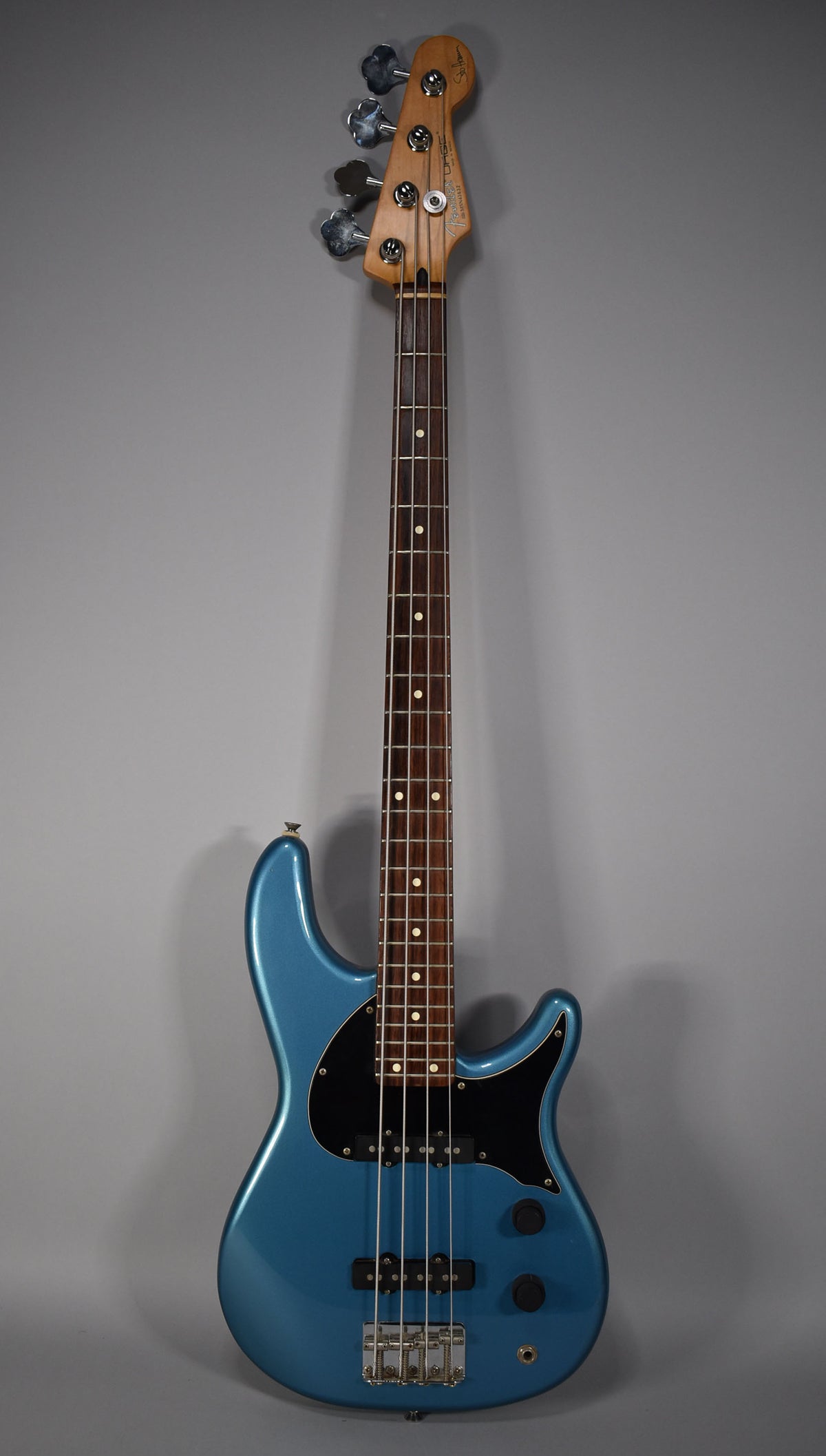 Full-length view of a Lake Placid Blue bass with a black pickguard, chrome hardware, and a rosewood fretboard with dot inlays.
