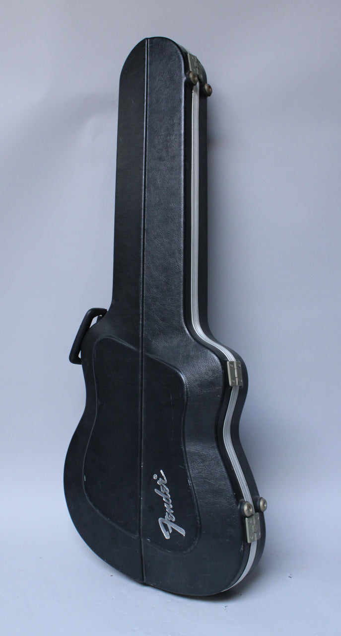 A black textured hard case for a guitar, viewed from the side, with silver trim and two visible tarnished latches.