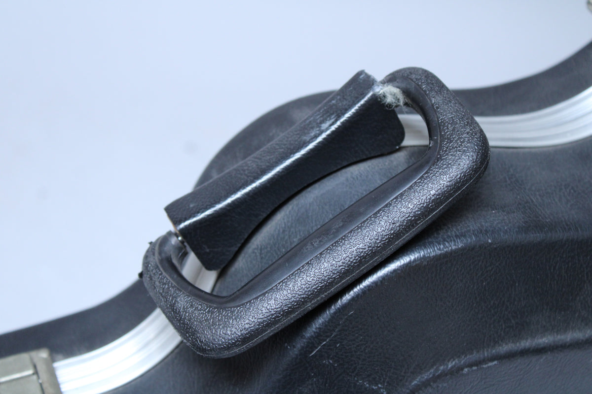 Close-up of the black textured plastic handle, showing wear on the faux leather grip and a white fuzzy tear at its base.