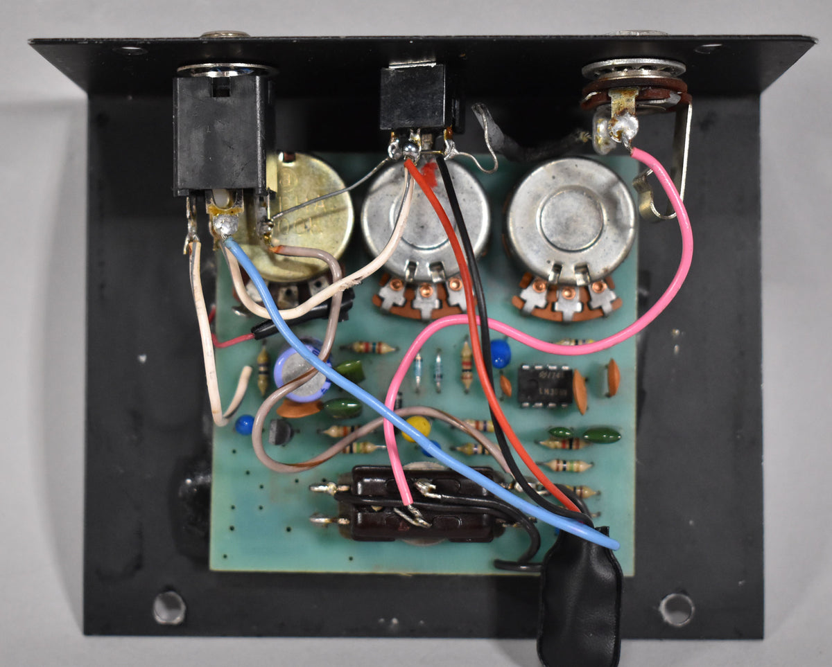 Overhead view of the pedal's internal circuit board, showing three potentiometers, various components, and colorful wiring.