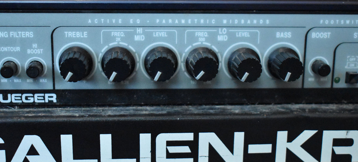Close-up of the top control panel of a Gallien-Krueger amplifier, showing various knobs and switches, with the brand name visible below.