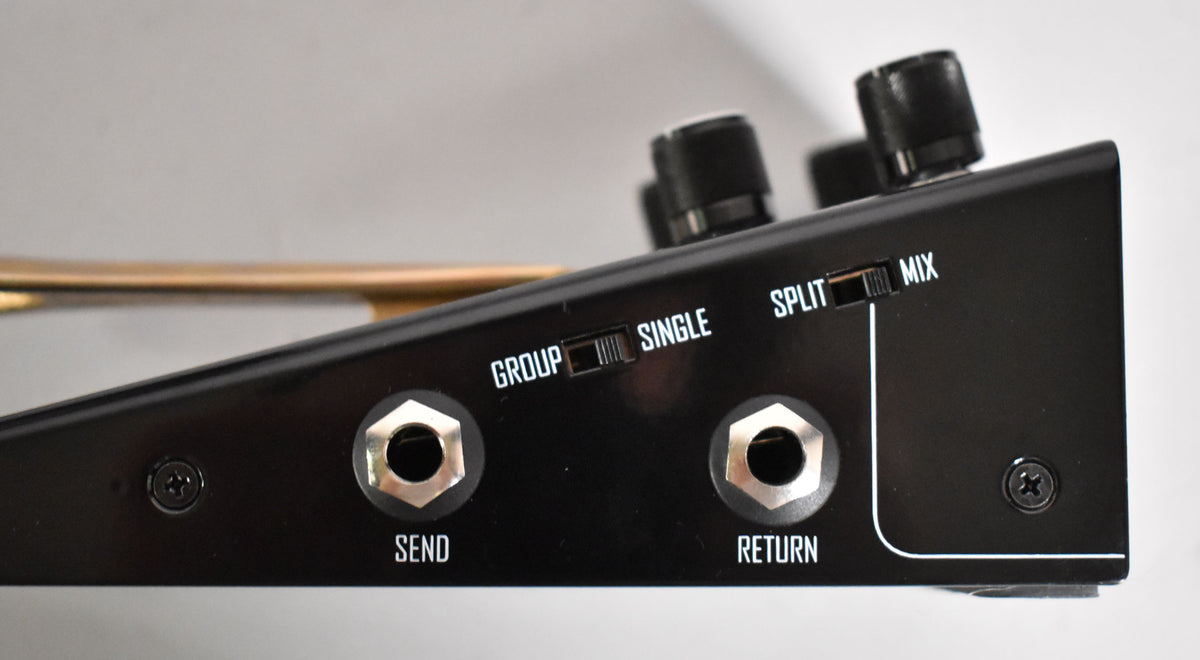 Close-up of the pedal's black side panel, showing "SEND" and "RETURN" jacks, plus "GROUP/SINGLE" and "SPLIT/MIX" toggle switches.