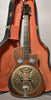 Full front view of a dark wood resonator guitar with a cutaway, two round mesh soundholes, and a tarnished gold resonator cone.