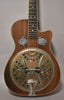 Full front view of a dark wood resonator guitar with a tarnished metal resonator cone and two round sound screens.
