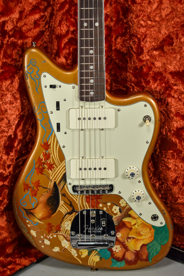 A Jazzmaster body, gold with a hand-painted bird and floral design, cream pickguard, two P90 pickups, and chrome hardware.