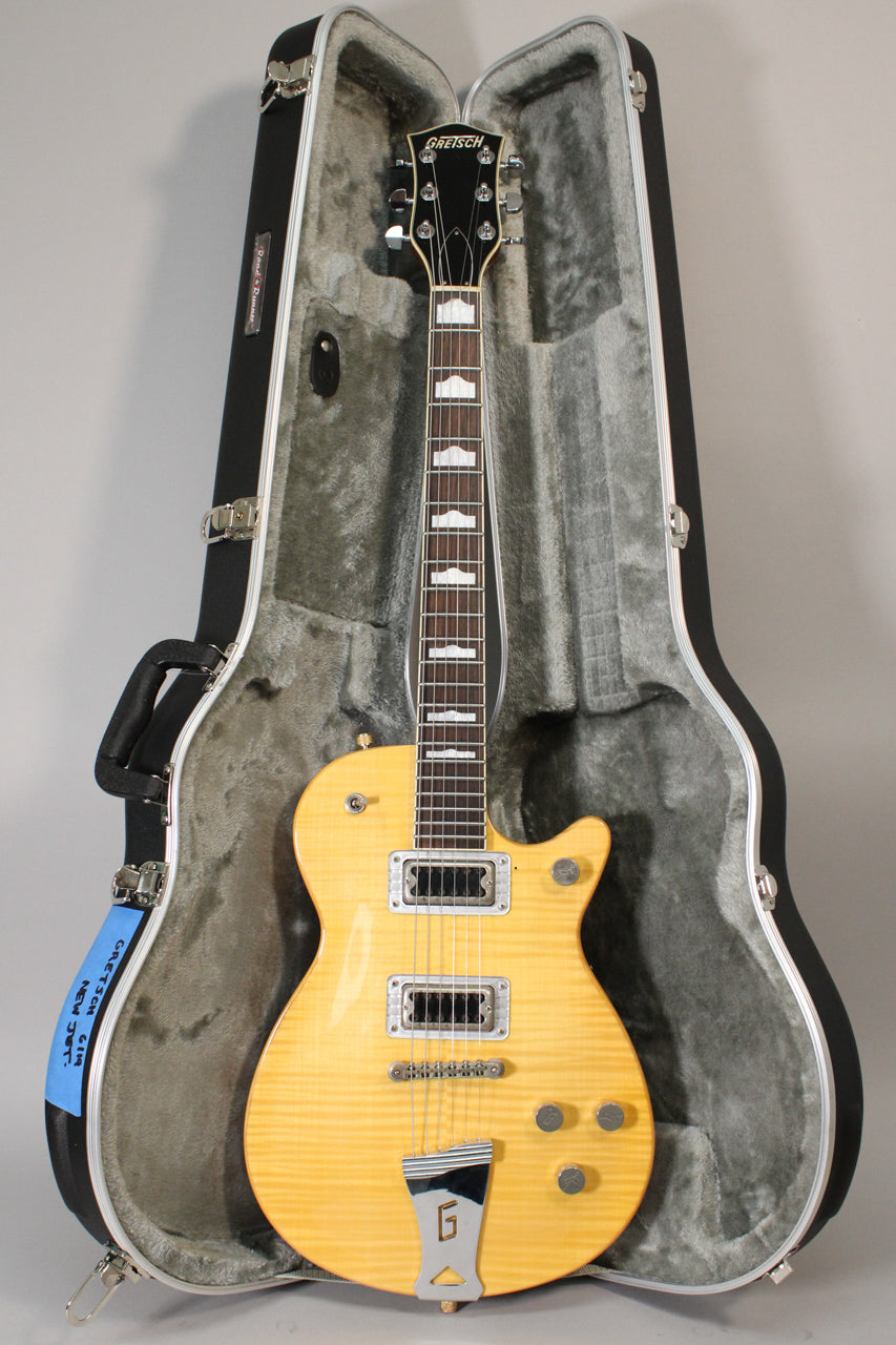 A Gretsch 6114A New Jet in antique maple, with a flamed top, chrome hardware, two humbuckers, and a G-cutout tailpiece, rests in its open hard shell case.
