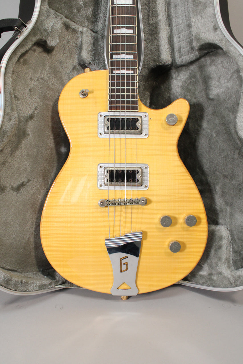 Full-front view of a light amber flamed maple guitar with two humbuckers, four chrome knobs, and a chrome G-logo tailpiece.