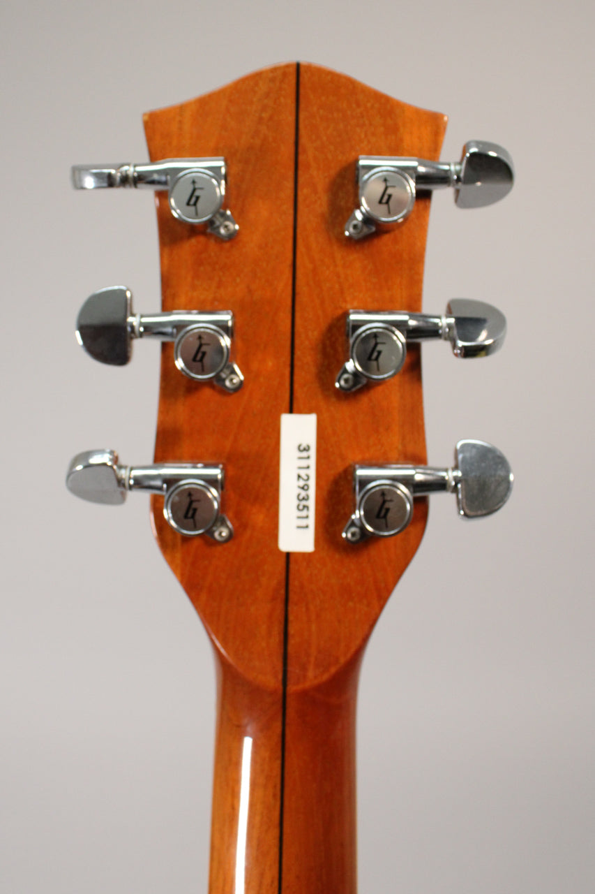 Rear view of the guitar's headstock and upper neck, showing six chrome tuners with "G" logos on a glossy antique maple finish.