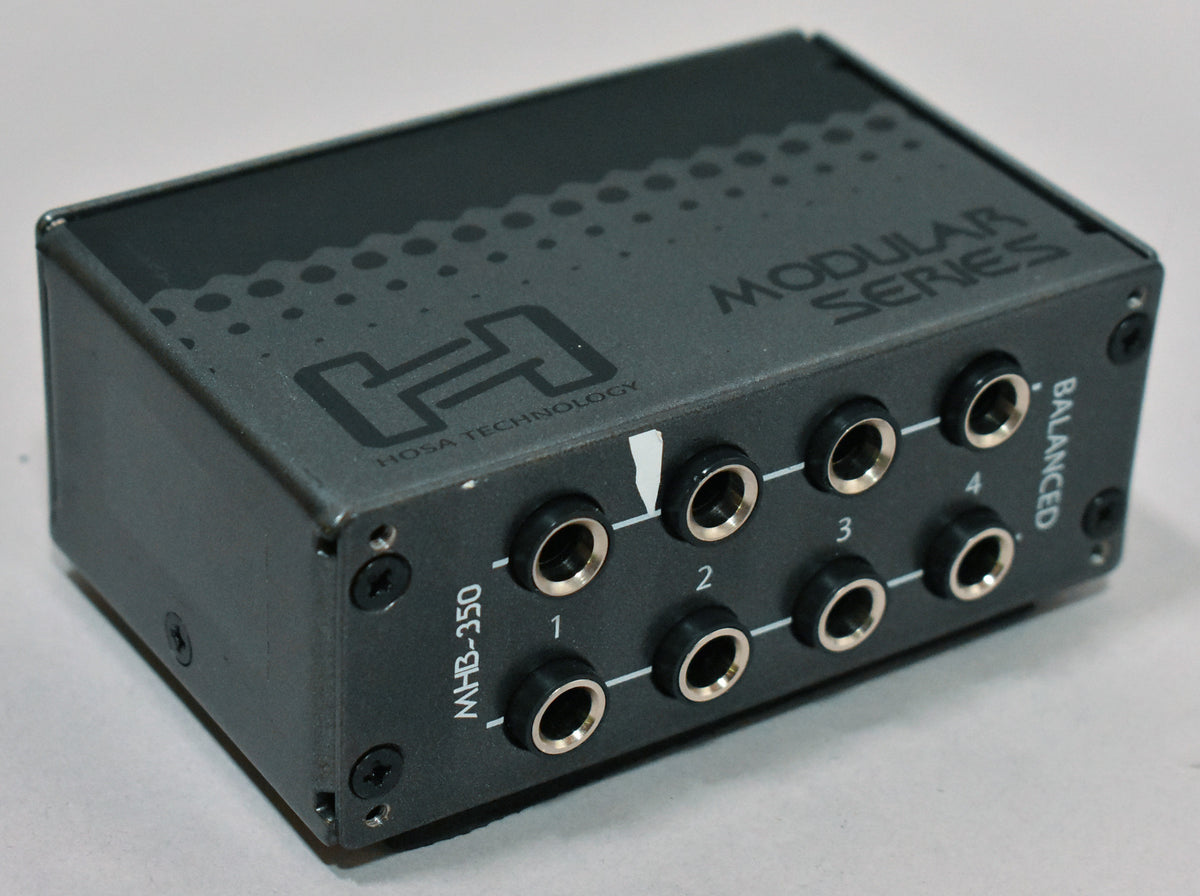 A dark gray patchbay module, angled to show the top and front panel with eight gold-ringed 1/4-inch jacks.