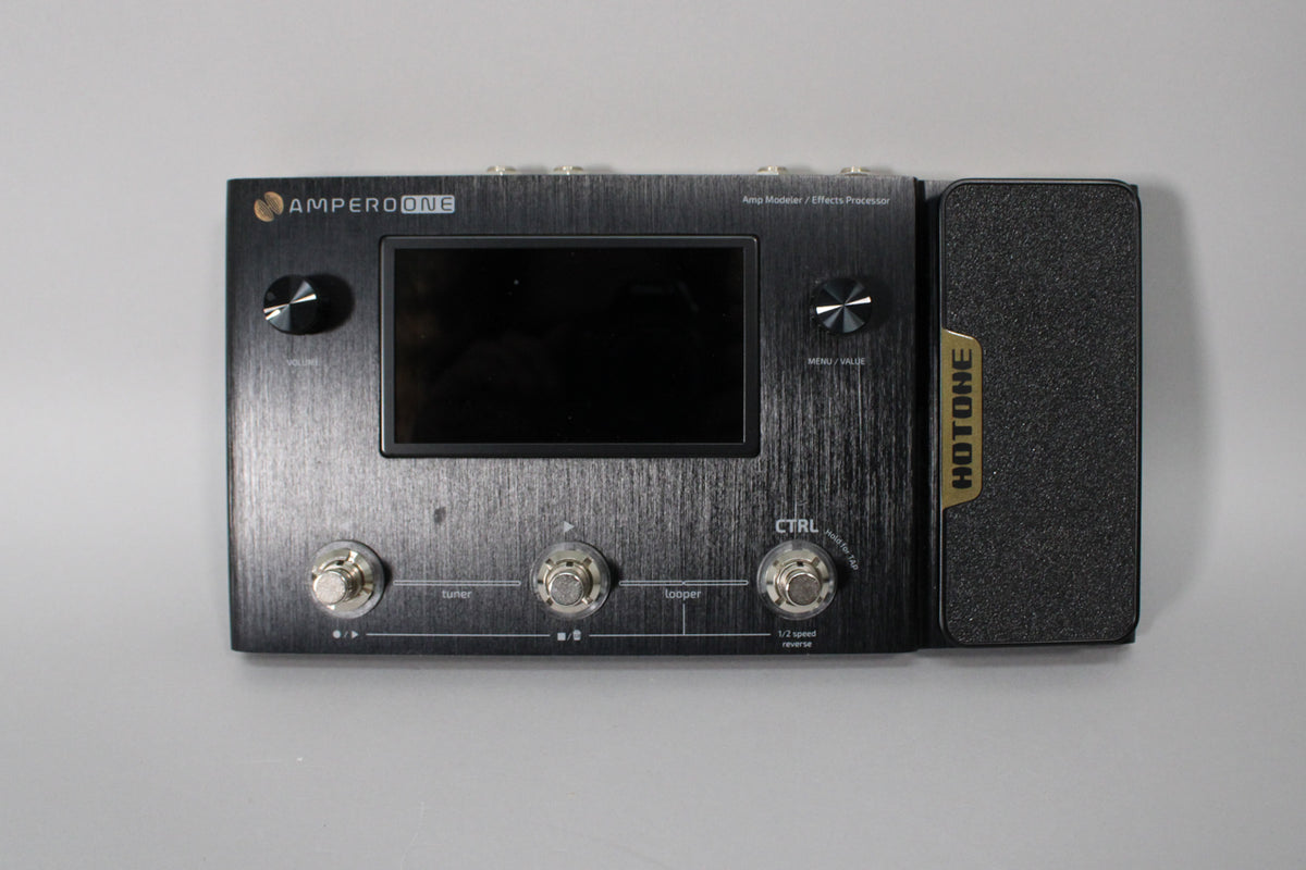 Overhead view of a black brushed metal multi-effects pedal with a screen, two knobs, three footswitches, and an expression pedal.