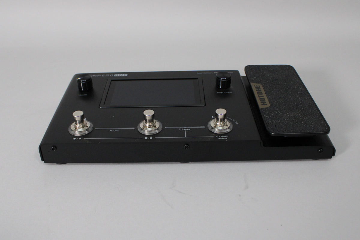 A black multi-effects pedal with a screen, three footswitches, two knobs, and an expression pedal, viewed from the right.