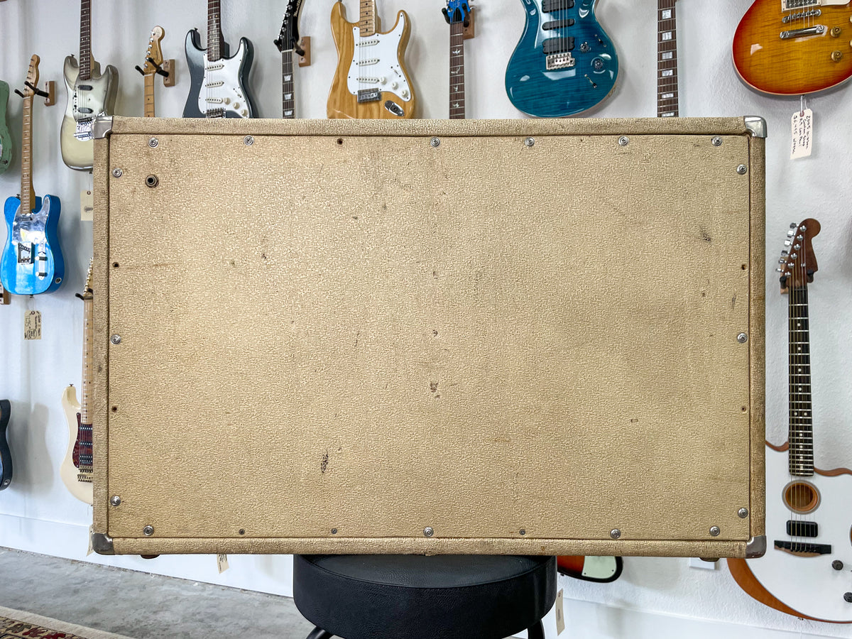 Rear view of the blonde speaker cabinet, showing its textured finish, metal corner protectors, and visible wear and scuffs.