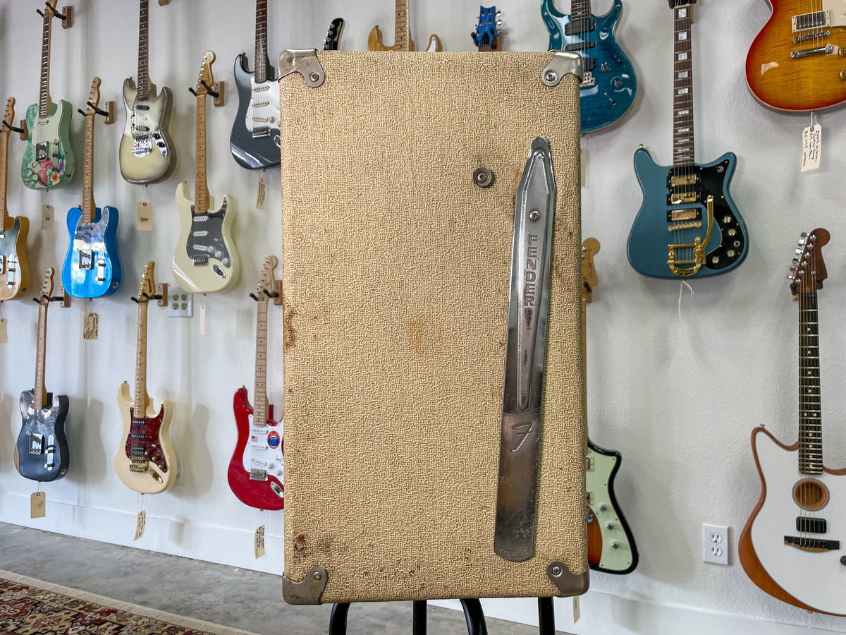 Full front view of a blonde textured speaker cabinet with a chrome tilt-back leg and corner protectors, showing some wear.