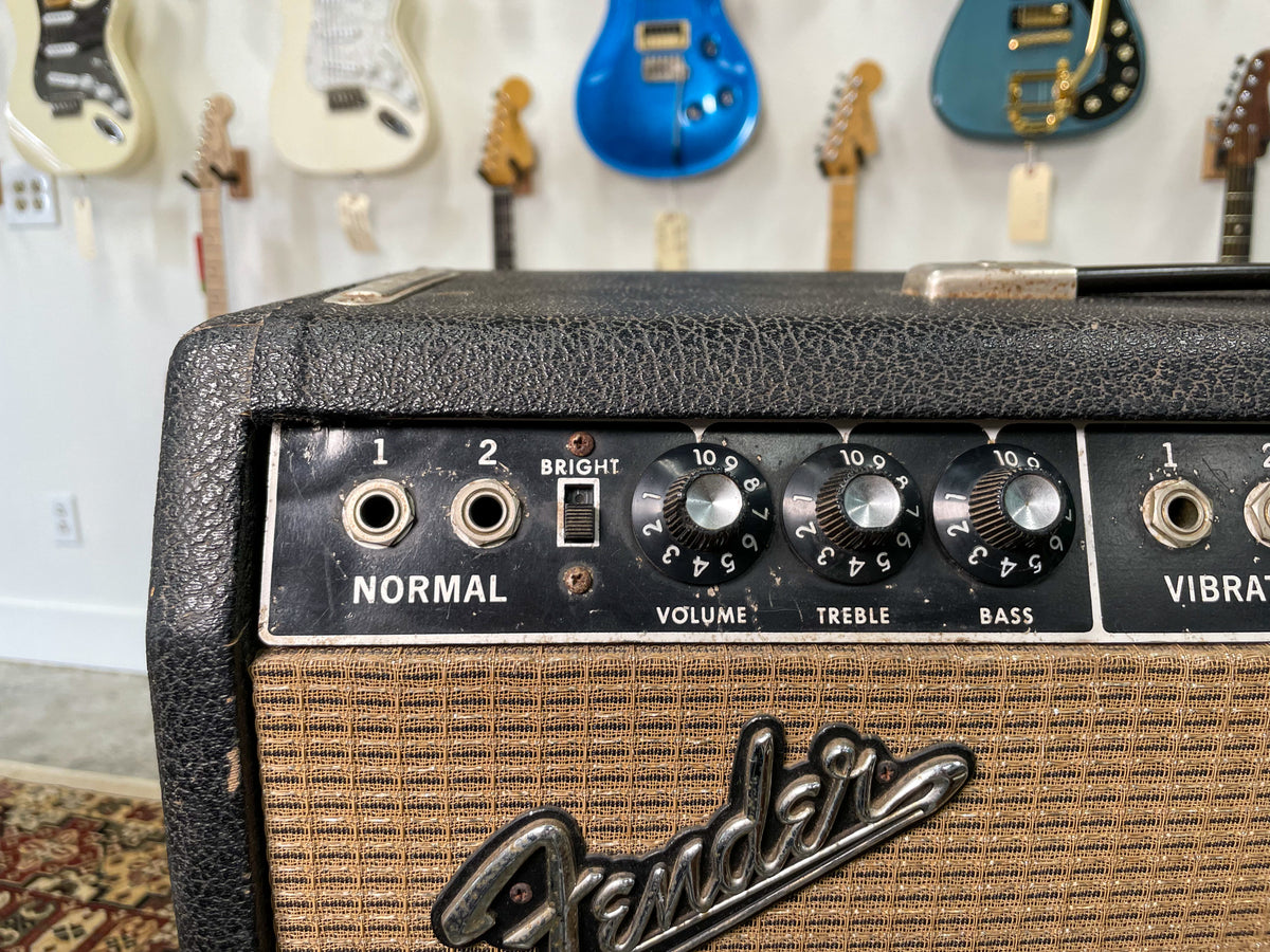 Close-up of the amp's black control panel with two input jacks, a "Bright" switch, and three black "Volume," "Treble," and "Bass" knobs.
