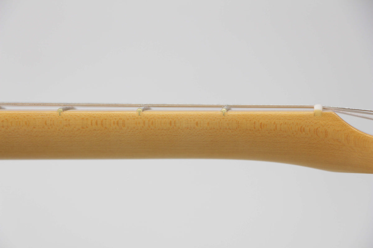 The guitar's light-colored maple neck is shown from the side, with strings and frets visible against a white background.