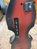 The bass's tobacco sunburst back, with a battery compartment, four control knobs, and a jack plate, is shown from an overhead angle.