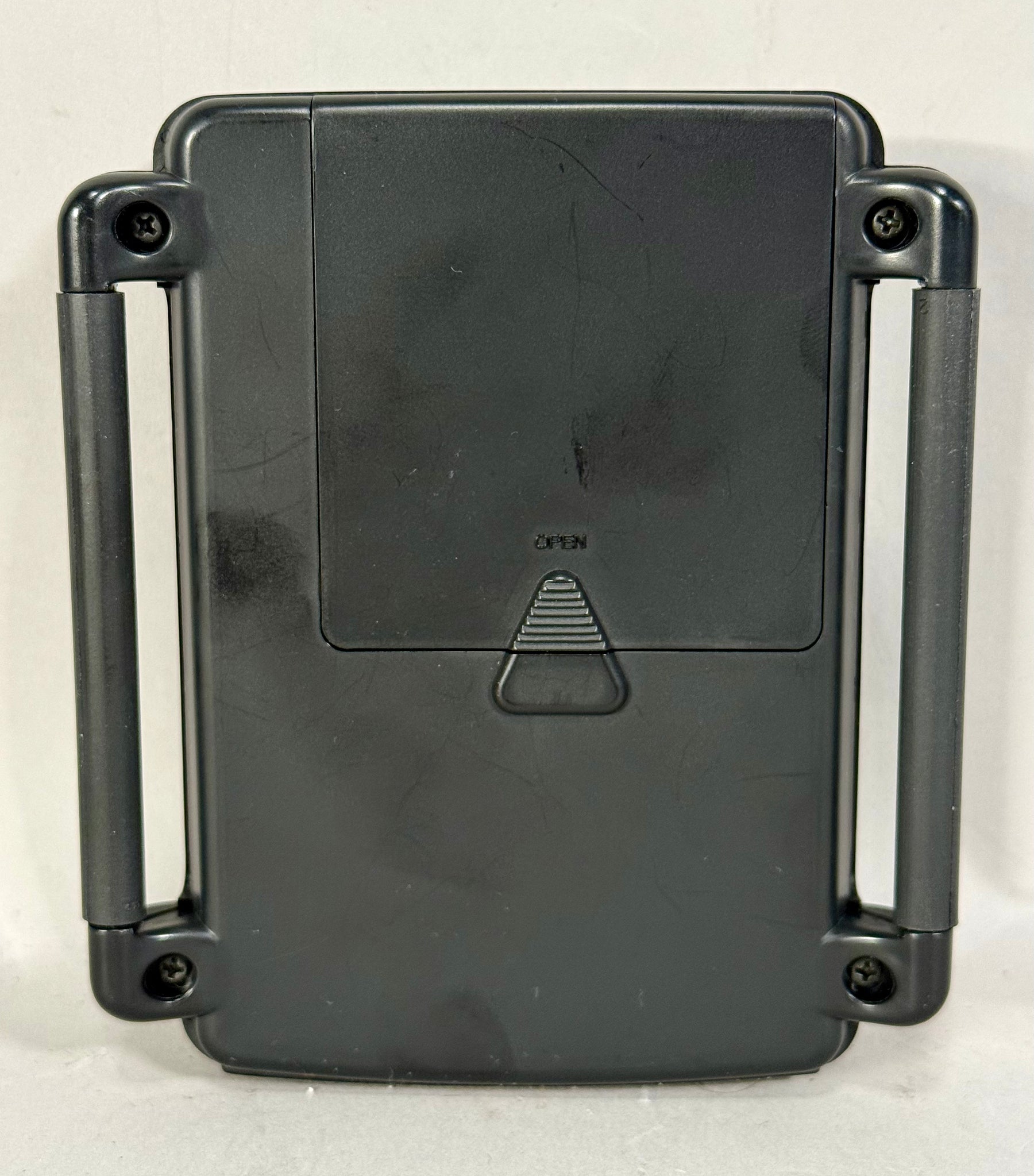 Rear view of the dark gray effects processor, showing the battery compartment with "OPEN" text and two side handles, with light scuffs.