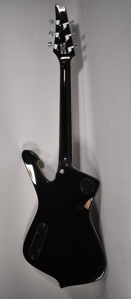 The back of the black guitar shows a glossy finish, chrome tuners, a neck plate, and two control cavity covers.