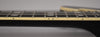 A close-up of the black guitar's fretboard, showing cream binding, dot side markers, and block inlays on the dark fretboard.