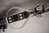 A digital caliper measures the black fretboard with pearloid block inlays, showing a reading of 1.73.