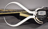 A digital caliper measures the string height at the 12th fret of the black guitar neck, displaying "0.97".